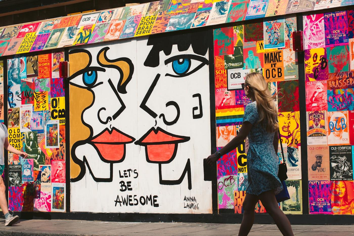 Street-art mural of two faces reading 'Let's be awesome'